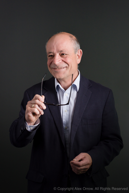 Engaged gentleman smiling holding glasses for Corporate Portrait Photograph