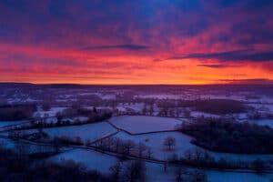 Aerial drone sunrise landscape over surrey fields